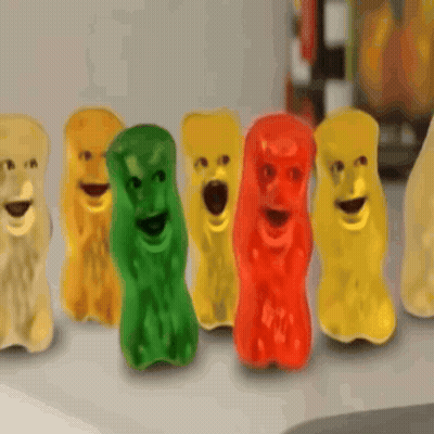 A Row Of Gummy Bears With Faces On Their Faces GIF