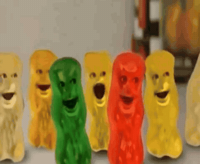A Row Of Gummy Bears With Their Mouths Wide Open GIF