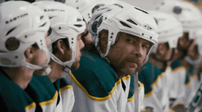 A Row Of Hockey Players Wearing Easton Helmets Sit On The Bench GIF