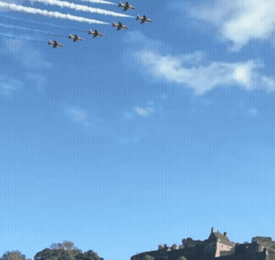 A Row Of Jets Flying In Formation With Red White And Blue Smoke Trails GIF