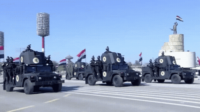 A Row Of Military Vehicles With The Number 13 On The Back GIF