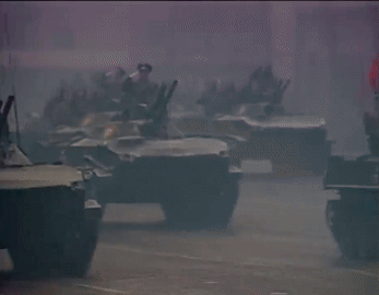 A Row Of Military Vehicles With The Number 7 On The Side Of One GIF