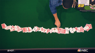 A Row Of Playing Cards On A Table With The Number 21 On The Table GIF