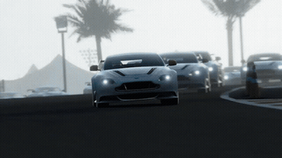 A Row Of Sports Cars Are Driving Down A Road With Palm Trees In The Background GIF