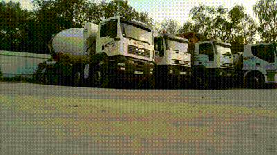 A Row Of Trucks Are Parked In A Parking Lot Including One That Says Man GIF