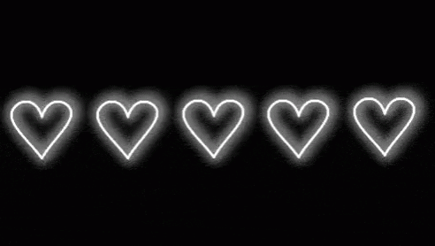 A Row Of White Hearts Glowing In The Dark On A Black Background . GIF