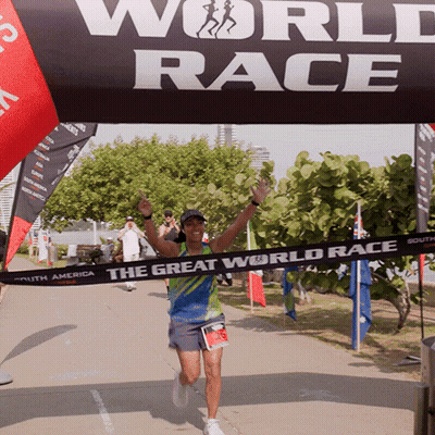 A Runner Is Crossing The Finish Line Of The Great World Race GIF