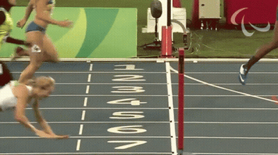 A Runner Is Falling On A Track With The Word Rio On The Side GIF