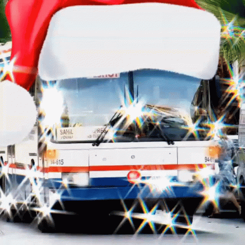 A Sahil Bus With A Santa Hat On The Front GIF