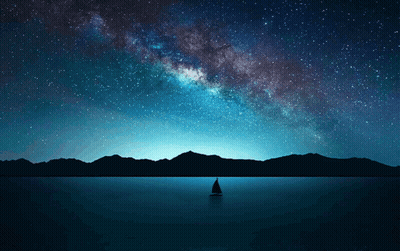 A Sailboat In The Middle Of A Lake With Mountains In The Background GIF