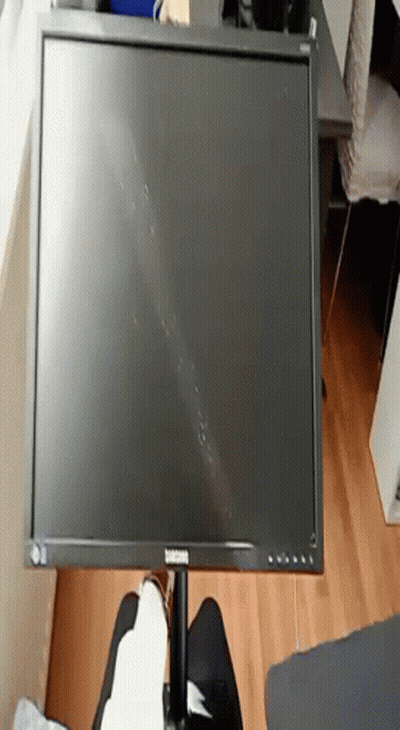 A Samsung Computer Monitor Is Sitting On A Table GIF