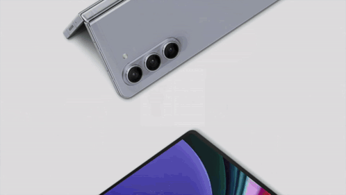 A Samsung Phone And A Tablet Are Laying On A Table GIF