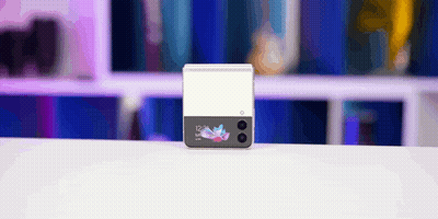 A Samsung Phone Is Sitting On A White Table With A Blurry Background GIF
