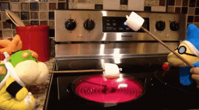 A Samsung Stove With Stuffed Animals Cooking Marshmallows On It GIF