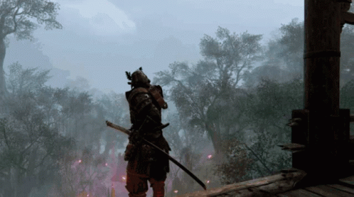A Samurai With A Sword Is Standing In The Middle Of A Forest GIF
