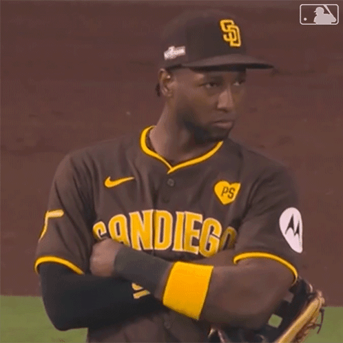 A San Diego Baseball Player With His Arms Crossed On The Field GIF