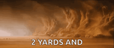 A Sand Storm In The Desert With The Words `` 2 Yards And '' Written In White Letters . GIF