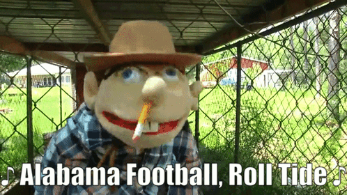 A Scarecrow With A Cigarette In His Mouth And The Words Alabama Football Roll Tide Below Him GIF