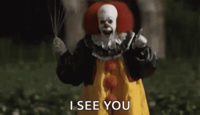 A Scary Clown Is Holding A Knife And A Balloon . GIF