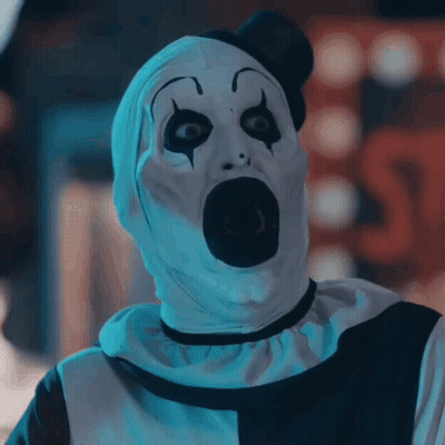 A Scary Clown With A Shocked Look On His Face GIF