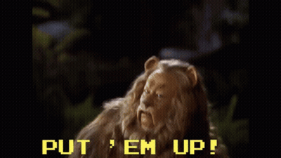 A Scene From The Wizard Of Oz With The Words Put Em Up Written On The Screen GIF