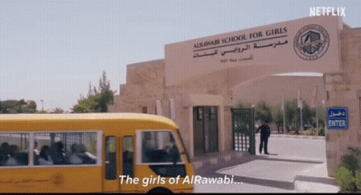 A School Bus Is Parked In Front Of A Sign That Says " The Girls Of Alrawabi " GIF
