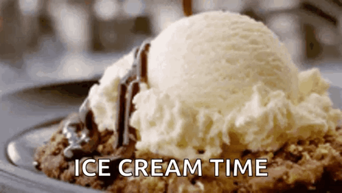 A Scoop Of Ice Cream Is Sitting On Top Of A Cookie Dough With Chocolate Sauce . GIF