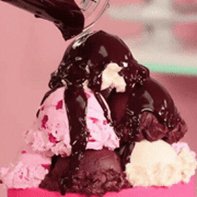 A Scoop Of Ice Cream With Chocolate Sauce On Top GIF
