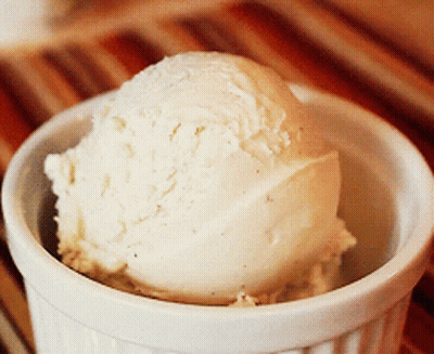 A Scoop Of Vanilla Ice Cream In A Bowl GIF
