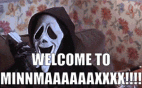A Scream Mask Is Sitting On A Couch Talking On A Cell Phone And Saying Welcome To . GIF