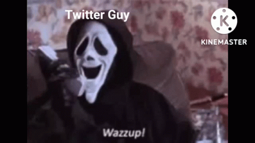 A Scream Mask Is Sitting On A Couch With A Phone In His Hand . GIF