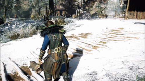 A Screenshot Of A Video Game Shows A Person Standing In The Snow Holding A Cat GIF