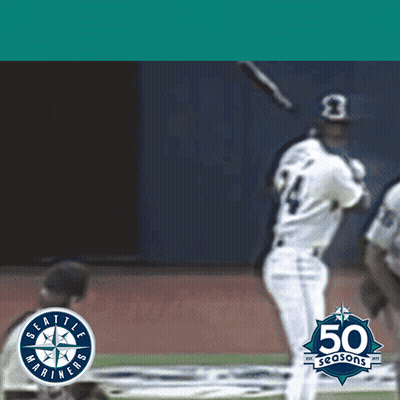 A Seattle Mariners Baseball Player Swings At A Ball GIF