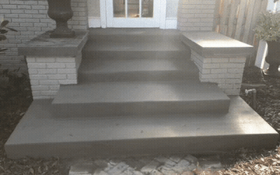 A Set Of Concrete Steps Leading Up To A House GIF