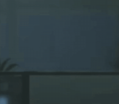 A Shadow Of A Person Is Casting On A Wall In A Room . GIF