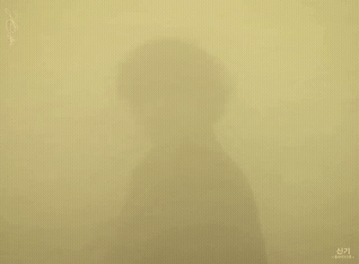 A Shadow Of A Person 'S Face Is Cast On A Wall GIF