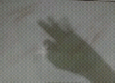 A Shadow Of A Person 'S Hand Pointing At Something GIF