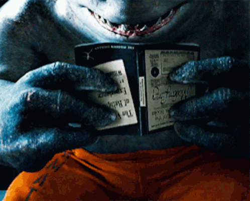 A Shark Is Holding A Book That Says " The Dark Knight " GIF