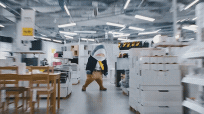 A Shark Mascot Is Walking Through A Store With A Sign That Says 39.99 GIF