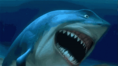 A Shark With Its Mouth Wide Open In The Ocean GIF