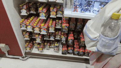 A Shelf Full Of Toys With One That Says ' Pokemon ' GIF