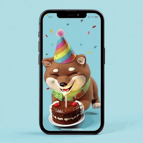 A Shiba Inu Wearing A Party Hat Is Holding A Cake GIF