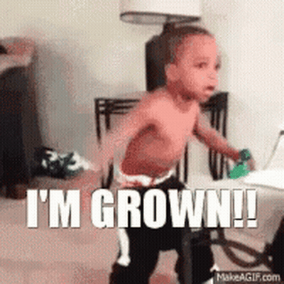 A Shirtless Baby Is Standing In A Room With The Words I 'M Grown ! GIF