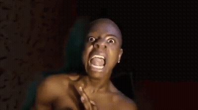 A Shirtless Bald Man Is Covering His Nose With His Hand . GIF
