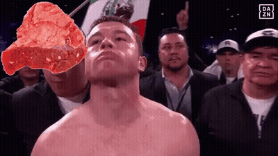 A Shirtless Boxer Stands In Front Of A Mexican Flag And A Large Piece Of Meat GIF