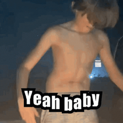 A Shirtless Boy Is Dancing With The Words `` Yeah Baby '' Written On His Chest . GIF
