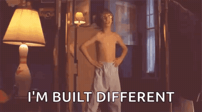 A Shirtless Boy Is Standing In A Room With His Hands On His Hips And Says `` I M Built Different '' . GIF