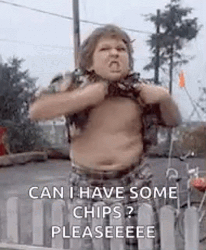 A Shirtless Boy Is Standing In Front Of A Fence . GIF