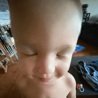 A Shirtless Child With His Eyes Closed And A Pacifier GIF