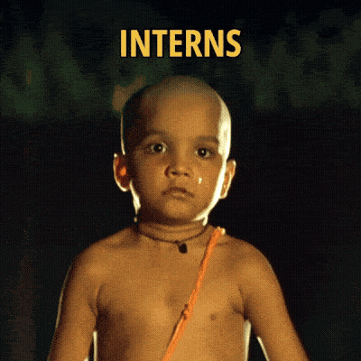 A Shirtless Child With The Word Interns Behind Him GIF